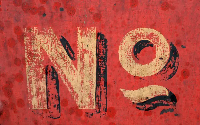 Weathered red sign with the word No