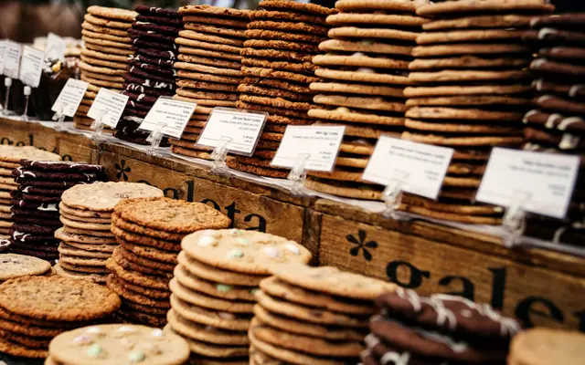 Stacks of cookies on a counter, each with a price tag