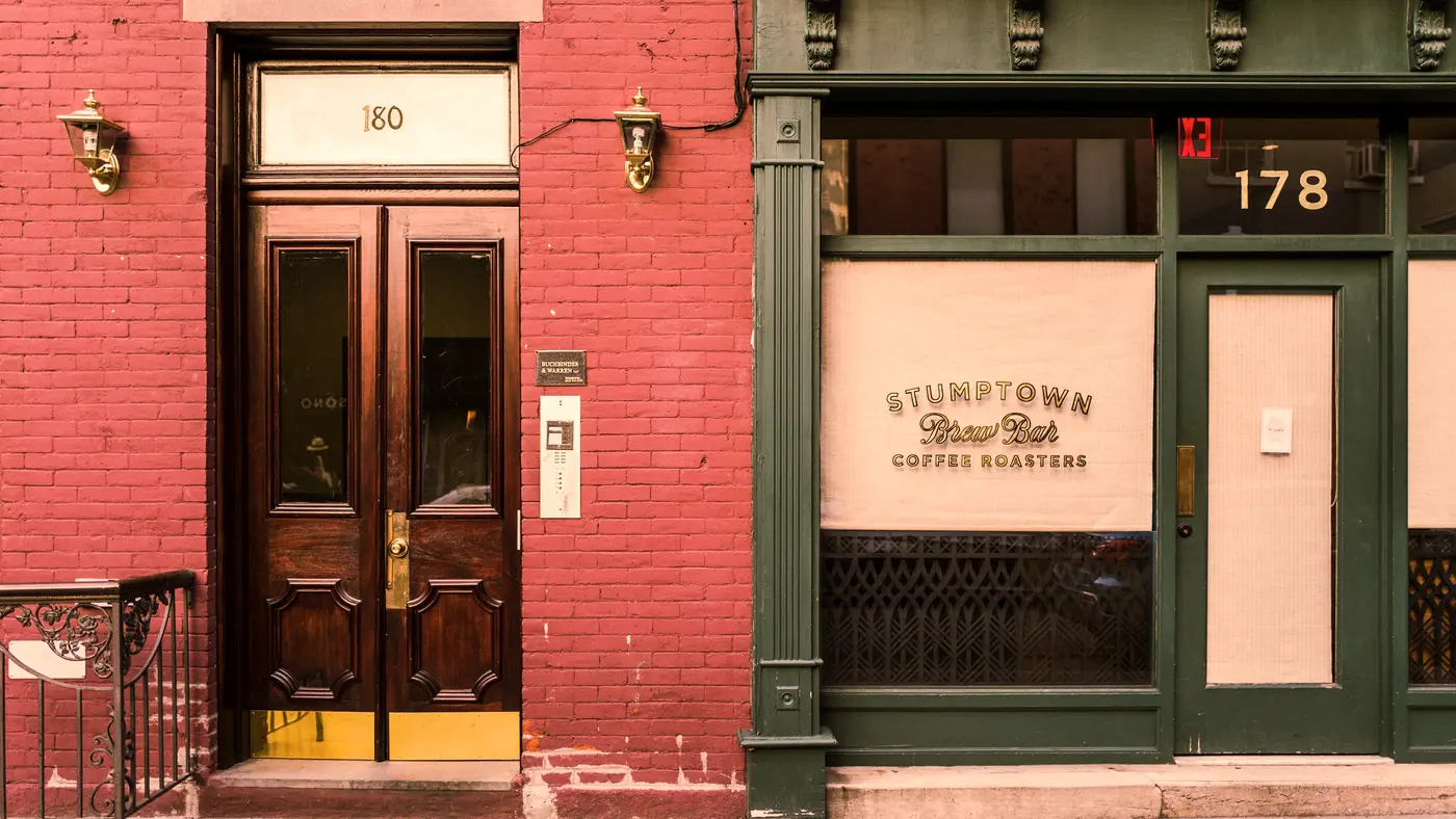 Brick storefront with a red entrance door