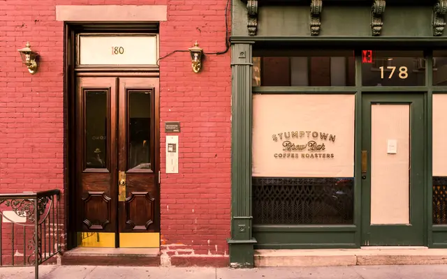Brick storefront with a red entrance door