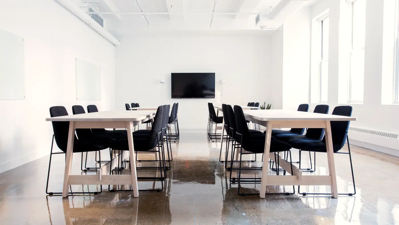 Bright training room with several tables and chairs