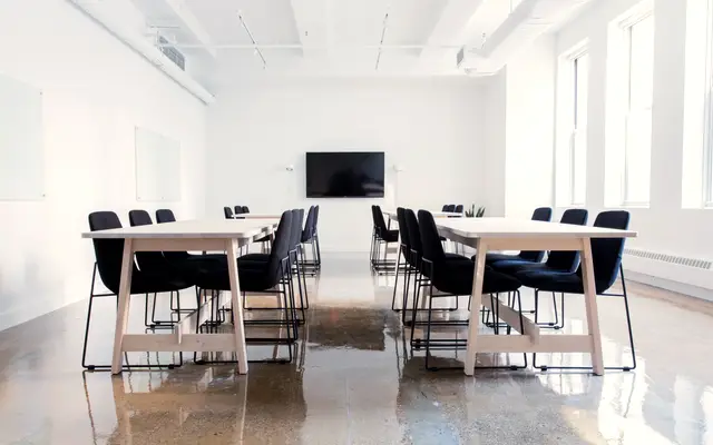 Bright training room with several tables and chairs