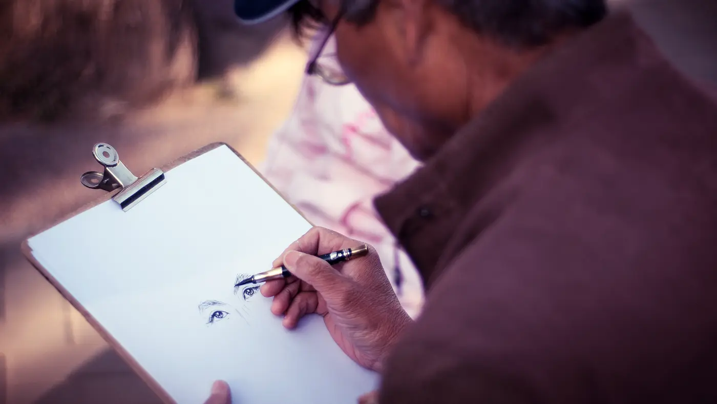 Man writing on a clipboard with a pen