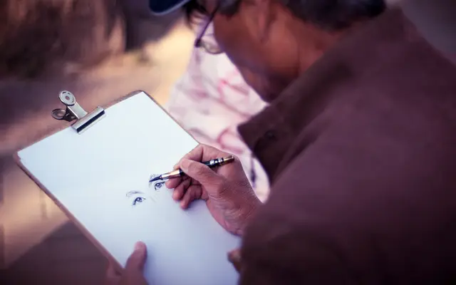 Man writing on a clipboard with a pen