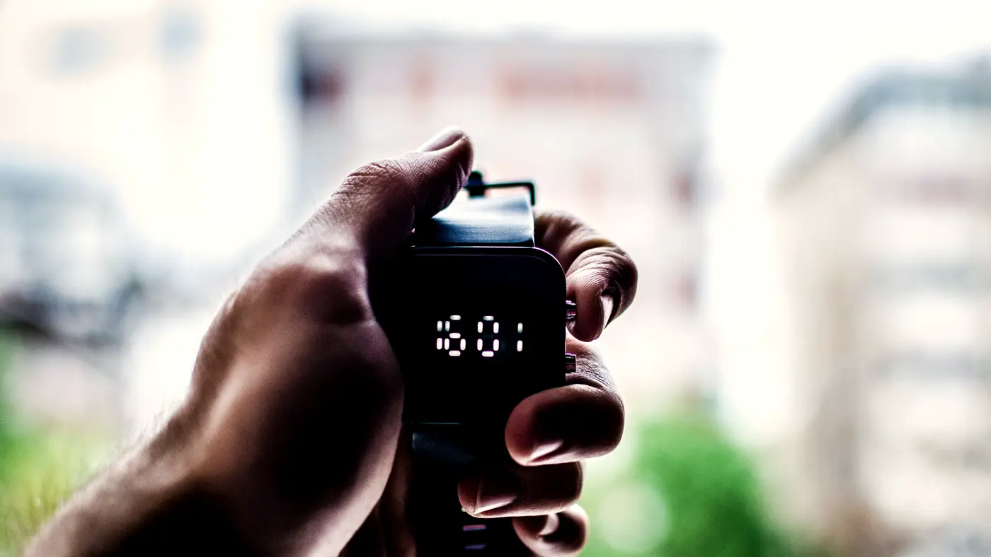Hand holding a digital stopwatch
