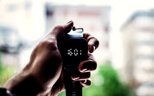 Hand holding a digital stopwatch