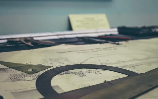 Technical drawing and drafting tools on a drawing table