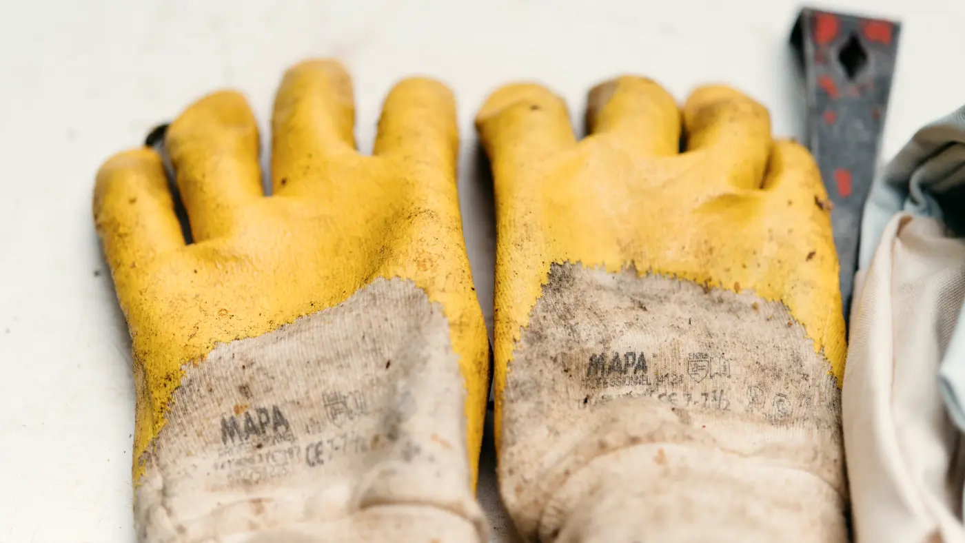 Pair of worn yellow work gloves