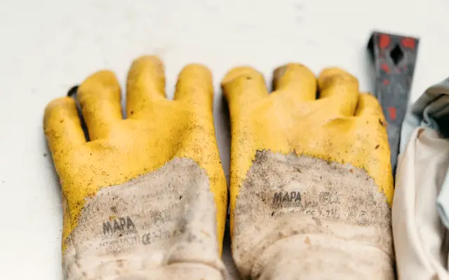 Pair of worn yellow work gloves