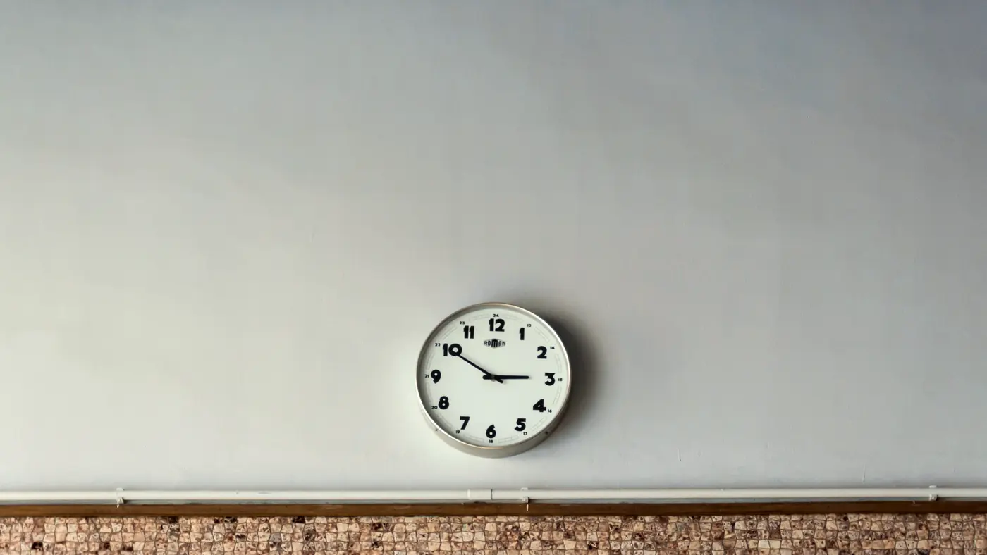 Simple wall clock on a plain light wall