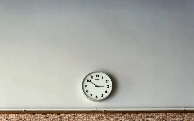 Simple wall clock on a plain light wall