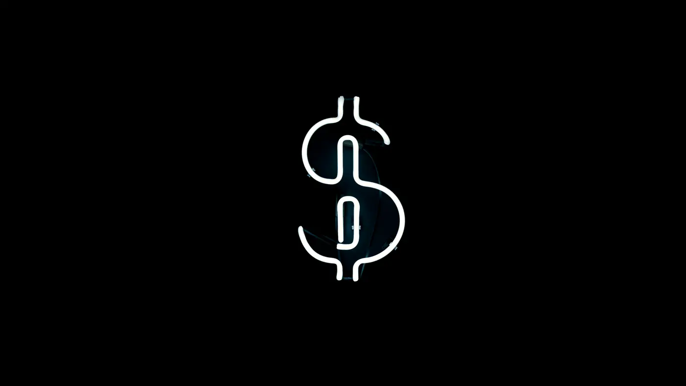 White neon dollar sign on a black background