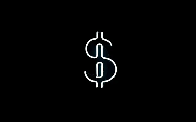White neon dollar sign on a black background