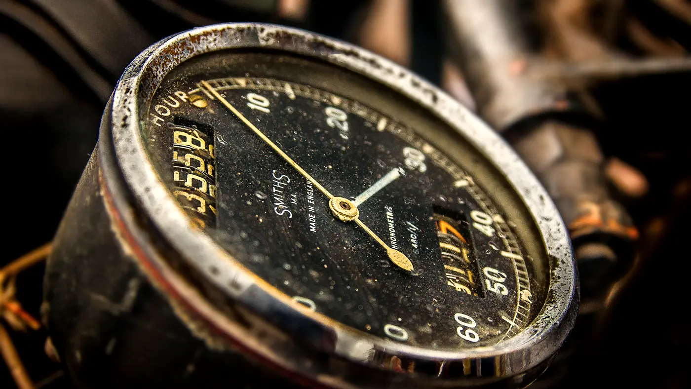 Close-up of an old analog gauge dial with a needle