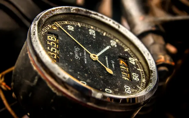 Close-up of an old analog gauge dial with a needle