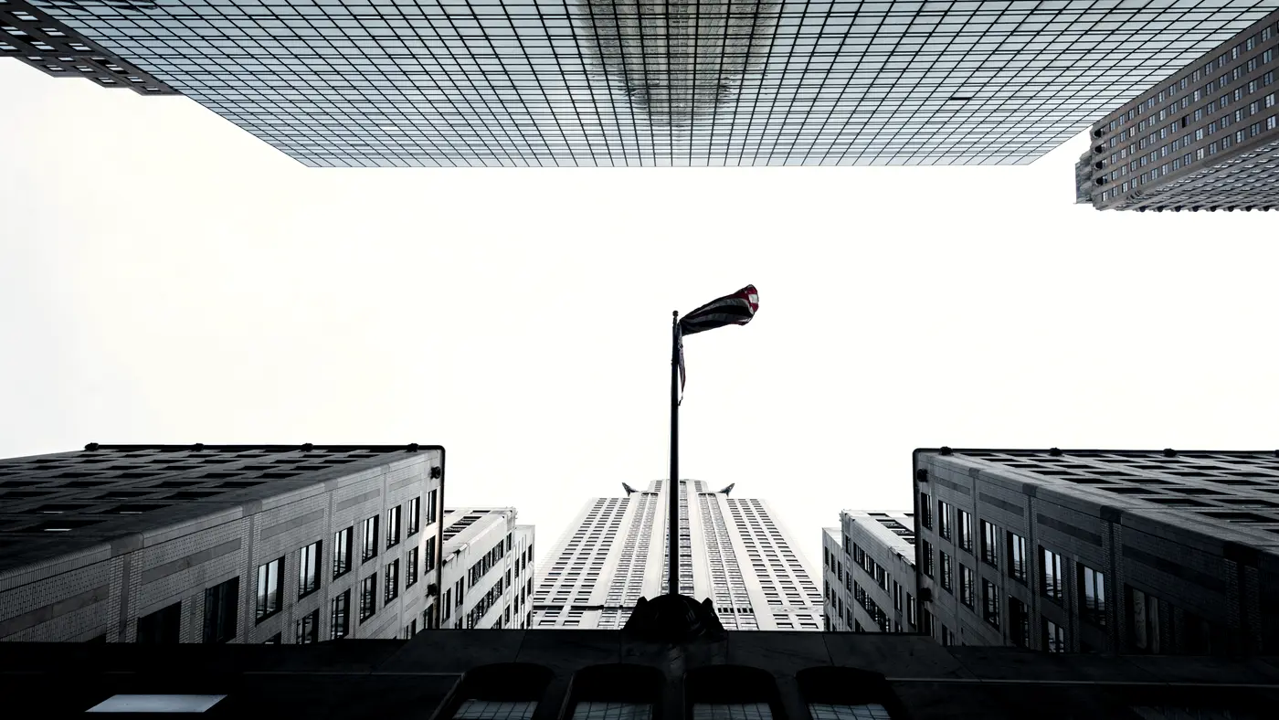 Looking straight up between tall glass office towers