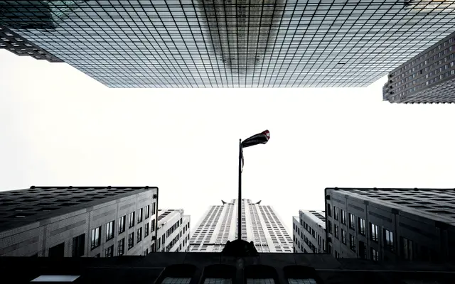 Looking straight up between tall glass office towers