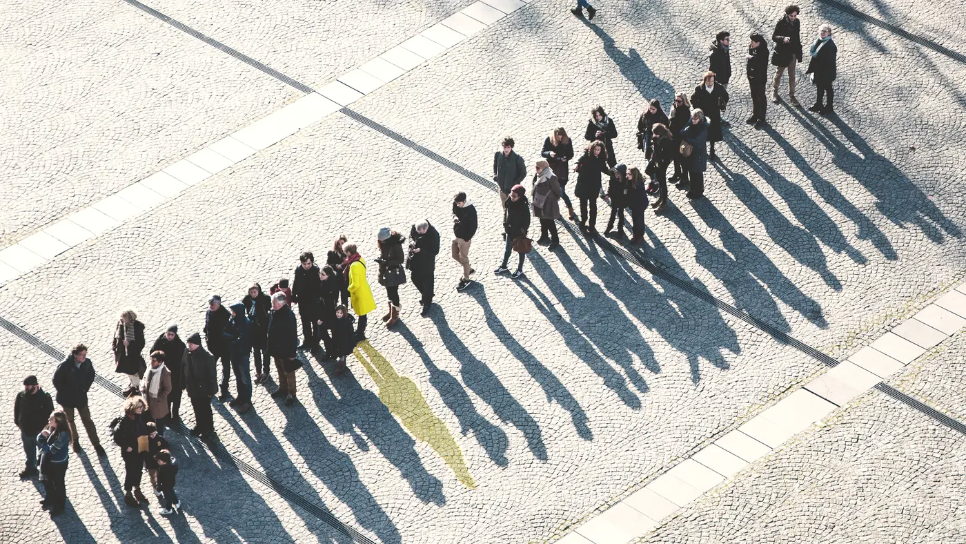 Aerial view of people waiting in a long single-file line