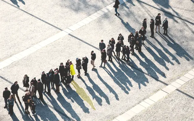 Aerial view of people waiting in a long single-file line